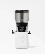 A modern, white electric juicer with a transparent upper container and black accents, shown against a plain white background. The front dial and juice spout are visible.
