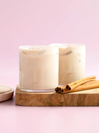 2 glasses of almond spice milk with cinnamon stick