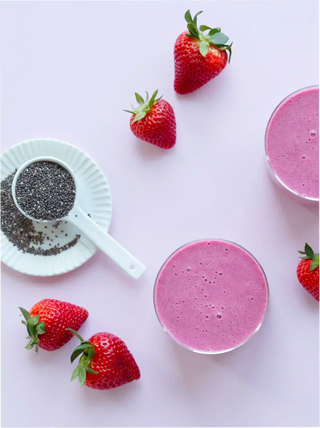2 glasses of berry fiber smoothie with  strawberries