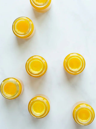 7 small bottles of golden yellow wellness shots