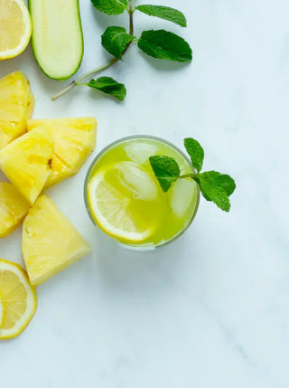 a glass of hydrating greens garnished with lemon