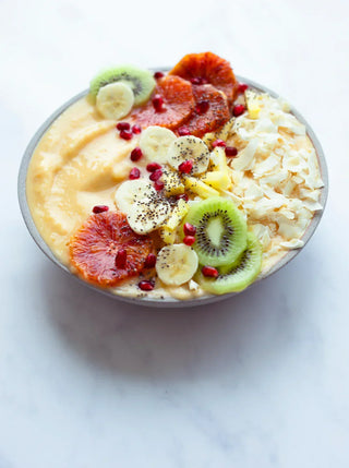 A smoothie bowl topped with granola and berries