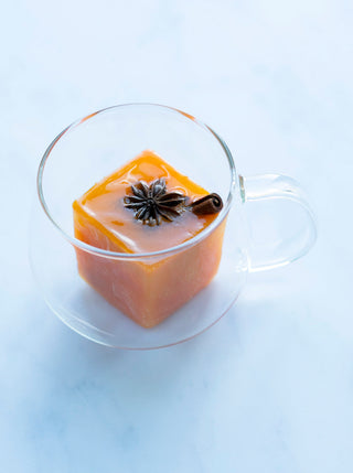 A glass teacup with a winter immunity cube