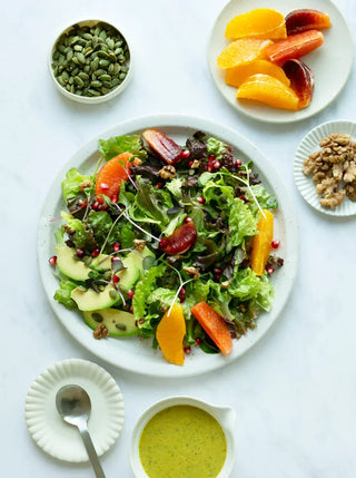 a plate of winter salad with citrus