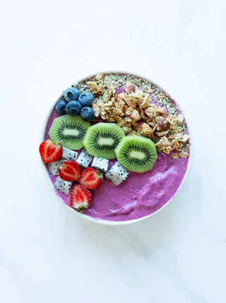 plant power bowl topped with berries kiwi granola and seeds