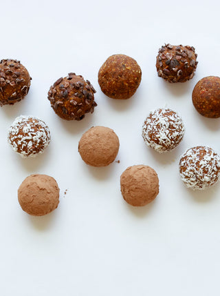 10 raw energy bites on a white surface