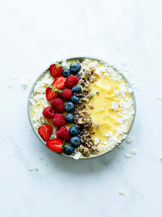 Sunshine Smoothie bowl topped woth coconut and berries