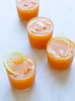 4 glasses of orange warm glow juice