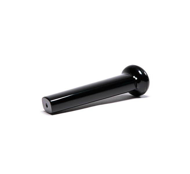 A black, cylindrical Pusher with a flared end and a small hole at the narrow tip, designed for use with the Nama Vitality 5800 cold press juicer, is shown resting on a white background.