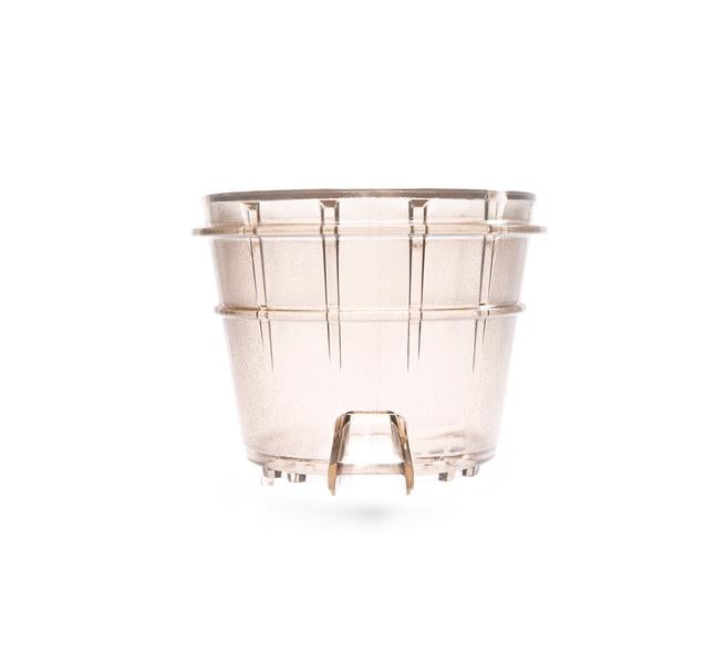 Transparent plastic plant pot with vertical ridges and drainage holes at the bottom, photographed against a white background—a functional accessory for every plant lover, as essential to healthy roots as a Sorbet Strainer is to refreshing desserts.