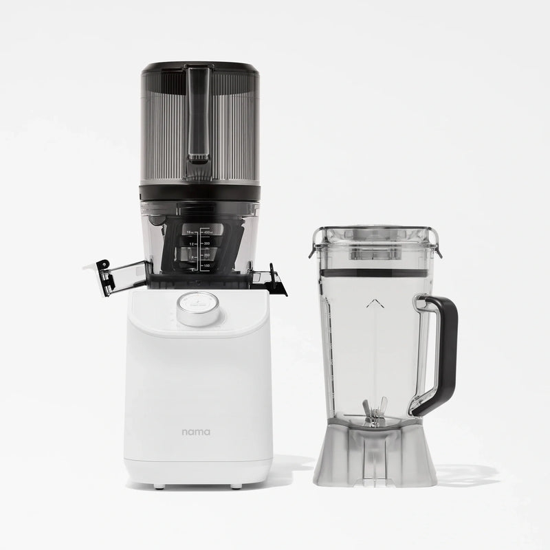 The Nama C2, a white multifunction juicer with a transparent top, is displayed next to its separate clear blender pitcher equipped with a black handle, both elegantly arranged against a plain white background.