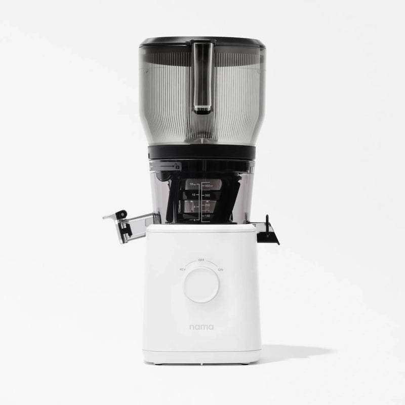 A modern white Nama J2 XL Cold Press Juicer featuring a spacious transparent top container, a central dial, and a convenient spout for dispensing juice, set against a plain white background. This easy-to-clean juicer combines style and functionality for your kitchen.