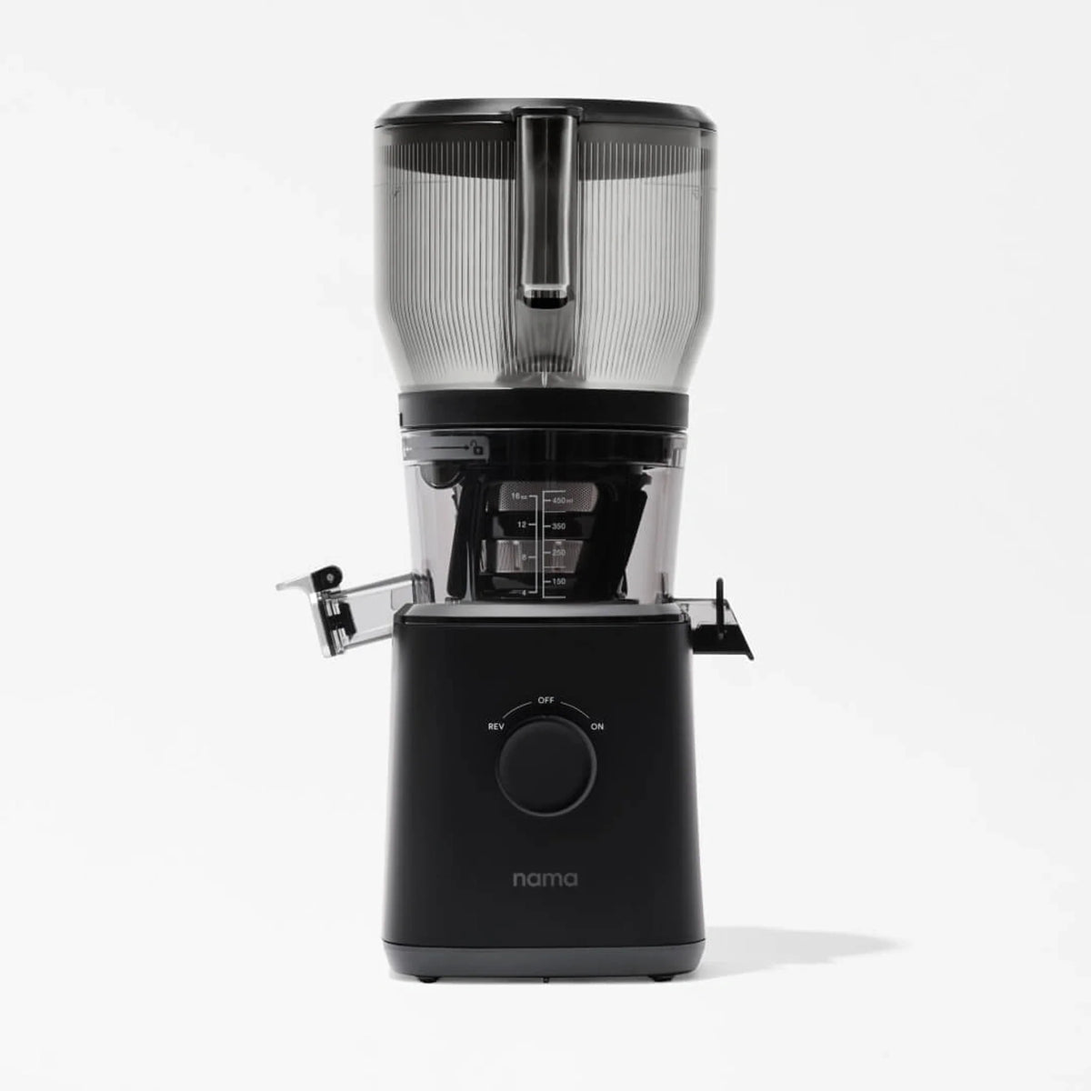 A black Nama J2 XL Cold Press Juicer with a clear container and lid, viewed from the front, sits on a plain white background. This cold press juicer features a round dial and two side spouts for juice and pulp, making it an easy-to-clean juicer that’s both stylish and functional.