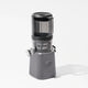 A sleek, gray Nama J2 juicer with a transparent container and lid, featuring a front dial and “nama” branding on the base, is photographed against a white background. Designed for easy cleaning, the Nama J2 is both stylish and practical for everyday cold press juicing.
