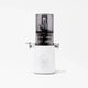 The Nama J3 is a modern cold press juicer featuring a white base, a central dial, and a transparent dark gray container on top, displayed against a plain white background.