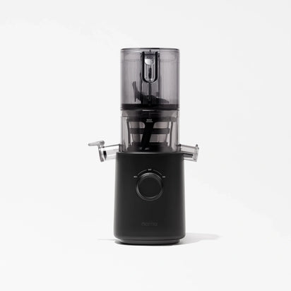 The Nama J3 cold press juicer, shown in sleek black and transparent design on a white background, features a cylindrical top chamber, dual side spouts, and a central control dial. Easy to clean and highly efficient, this portable juicer blends style with functionality for fresh juice anytime.