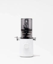A modern white and transparent juicer with a central dial and side spouts, set against a plain white background.
