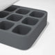 A close-up of the Ice Cube Tray, featuring six square compartments made of gray silicone, displayed on a white surface.