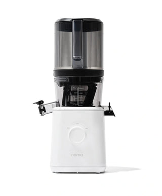 A modern white and black juicer with a transparent container and control dial, shown on a plain white background. The brand name nama is visible on the front of the juicer.