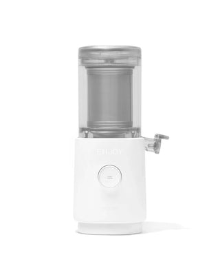 A white countertop appliance with a transparent container and spout, resembling a juicer or cold press, set against a plain white background.
