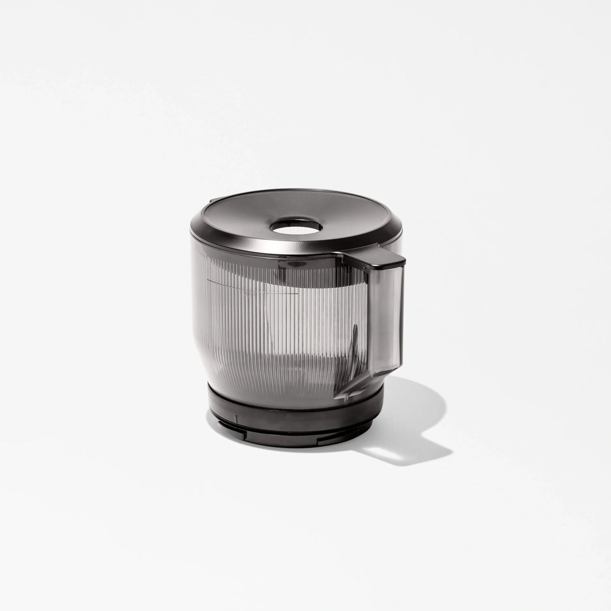 A transparent plastic blender or food processor jar with a black lid and handle sits on a white background, casting a soft shadow—perfect for pairing with your Large Hopper for efficient batch juicing.