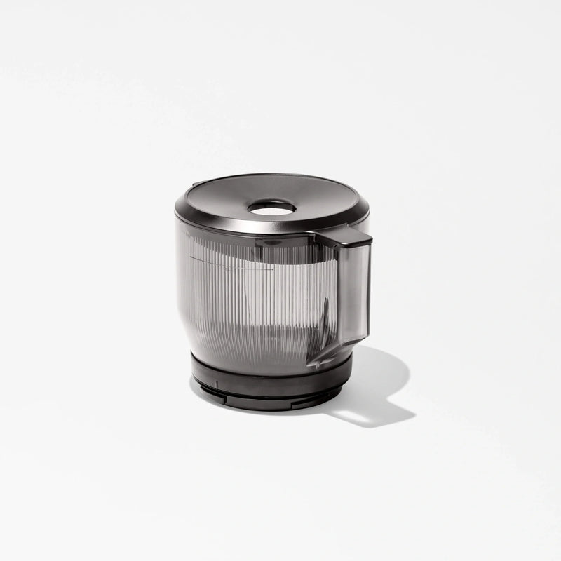 A transparent plastic blender or food processor jar with a black lid and handle sits on a white background, casting a soft shadow—perfect for pairing with your Large Hopper for efficient batch juicing.