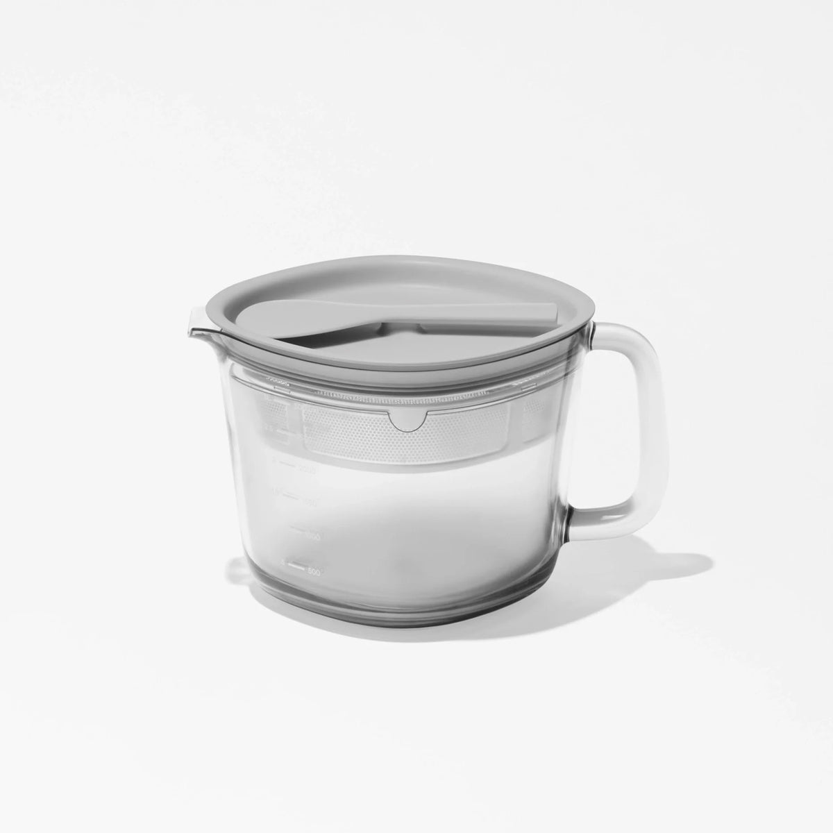 Large Pitcher Set featuring a clear plastic measuring cup with a handle and a gray lid, displayed on a plain white background. The pitcher includes measurement markings and an integrated strainer in the lid, making it ideal for juice storage or as an essential juicer accessory.