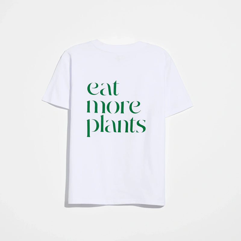 The Eat More Plants T-shirt is a relaxed fit tee crafted from 100% combed cotton for ultimate comfort. This white shirt features the phrase “eat more plants” printed in bold green letters on the back and is displayed against a plain white background.