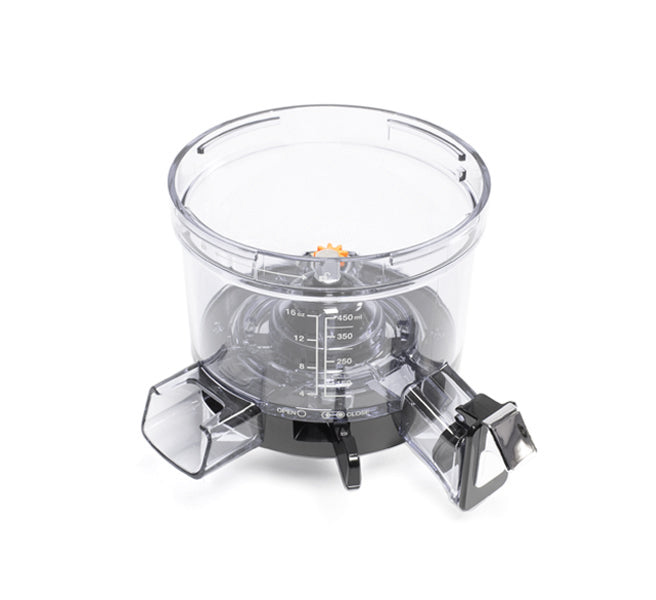 Clear plastic Chamber with measurement markings, two angled spouts, and a black base; designed for use with the Nama Vitality 5800 Cold Press Juicer as a mixing or dispensing bowl, shown against a white background.
