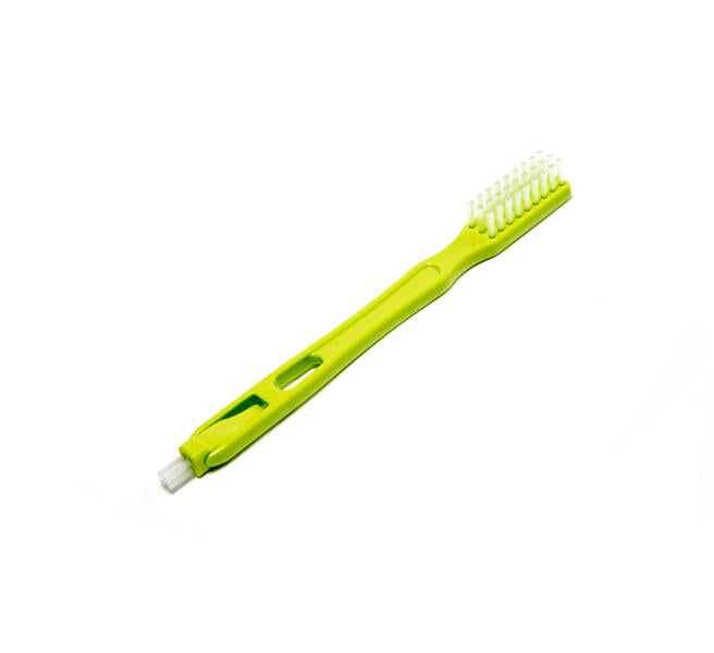 A green double-ended Cleaning Brush featuring a regular brush on one end and a small, pointed brush on the other is displayed on a white background—perfect for maintaining oral hygiene or cleaning hard-to-reach parts of your Nama Vitality 5800 Cold Press Juicer.