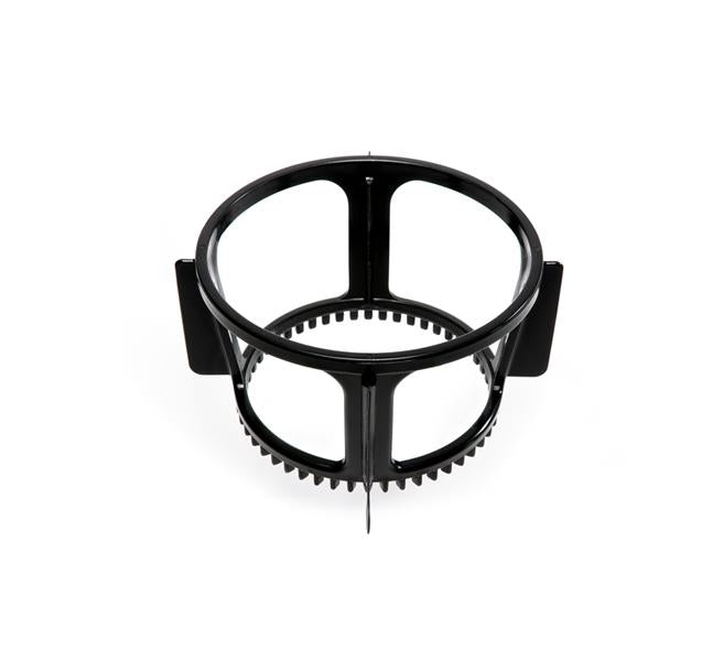 Black circular plastic ring with vertical supports, a toothed inner base, and two flat rectangular tabs extending outward—identified as the Spinning Brush, a component for the Nama Vitality 5800 Cold Press Juicer. This part is designed to support the juicing process by working in conjunction with other components. Shown against a white background.
