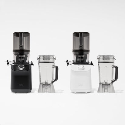 Two Nama C2 cold press juicers, one black and one white, each with matching juice and pulp containers, are displayed side by side on a white background.