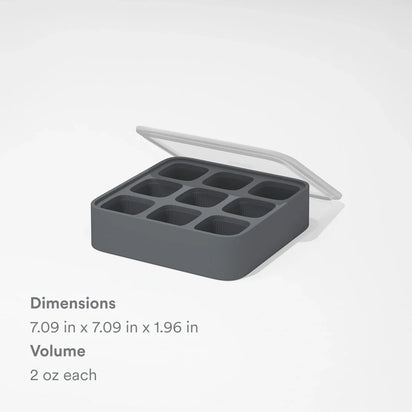 The Nama Ice Cube Tray is a black silicone tray with a clear lid, featuring nine square compartments, each holding 2 oz. Dimensions are 7.09" x 7.09" x 1.96".