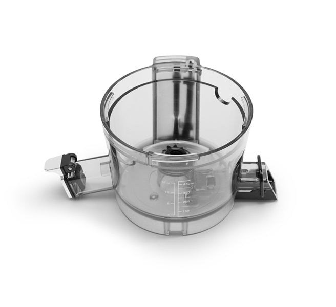 Clear Chamber food processor bowl with handle and measurement markings, shown on a white background. The main compartment of the Chamber is designed for efficient ingredient processing—ideal for pairing with appliances like the Nama J2 Cold Press Juicer to manage juice extraction or other food prep tasks.