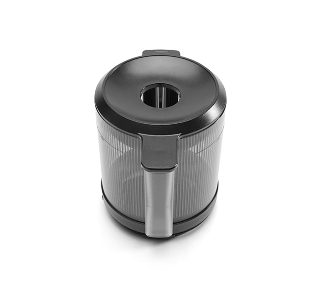 The Hopper Assembly, designed for the Nama J2 Cold Press Juicer, is a black and transparent plastic self-feeding canister featuring a central hole on top, a side handle, and a ridged texture. It is displayed elegantly on a white background.