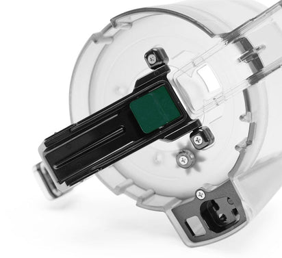 Close-up of the Pulp Outlet Gasket, a transparent plastic component with a black latch and green button, includes metal screws and mechanical parts—designed for the Nama C2 Cold Press Juicer.