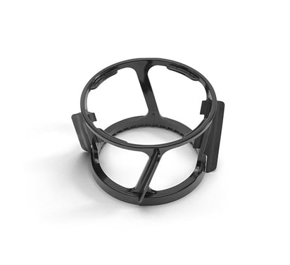 A Spinning Brush—black, circular, and made of plastic with four vertical supports and open sections, designed to hold components like the Nama J2 Cold Press Juicer spinning brush and juice strainer—is shown on a white background.