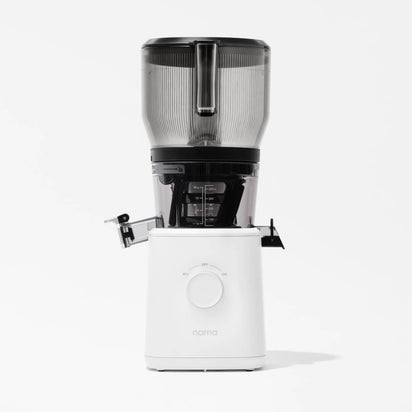 The Nama J2 XL Cold Press Juicer features a clear top, black middle, and white base with a central control dial and "nama" branding. Photographed on a white background, it's an easy-to-clean juicer perfect for any kitchen.