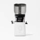 The Nama J2 XL Cold Press Juicer features a clear top, black middle, and white base with a central control dial and "nama" branding. Photographed on a white background, it's an easy-to-clean juicer perfect for any kitchen.