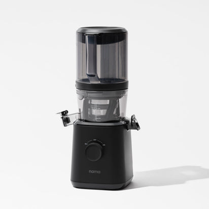 The Nama J2 Plug Type I is a sleek, modern black cold press juicer with a clear top section for fruits, front control dial, and separate juice and pulp spouts, shown against a plain white background.