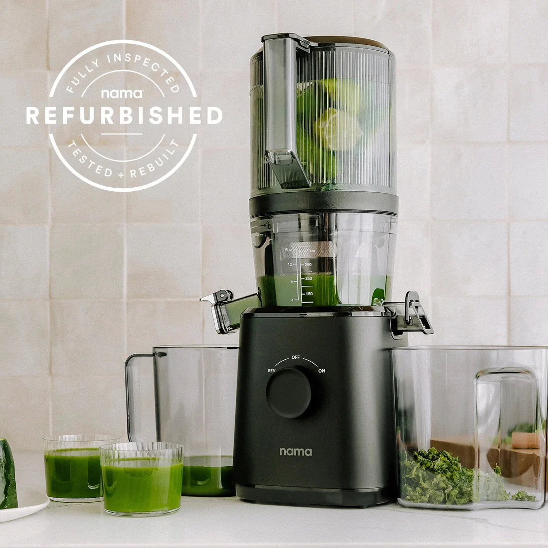 A Refurbished Nama J2 by Namawell sits on a kitchen counter, surrounded by glasses and containers of green juice and pulp. Text reads: Fully Inspected, Nama Refurbished, Tested, Rebuilt.