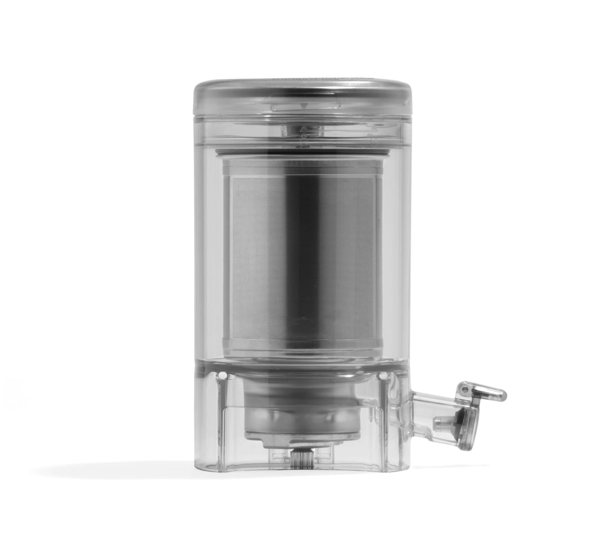 A transparent, cylindrical plastic Chamber Set featuring a built-in metal filter and a small spout with a lever at the bottom right, designed to work seamlessly with the Nama M1 Plant-Based Milk Maker for producing high-quality milk.