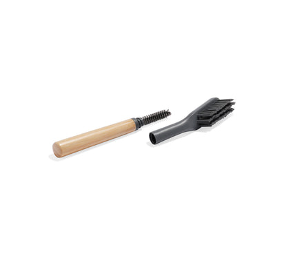 The Cleaning Brush, featuring a wooden handle and black bristles, is shown next to a black plastic attachment on a white background—ideal for keeping your Nama M1 or Plant-Based Milk Maker spotless.
