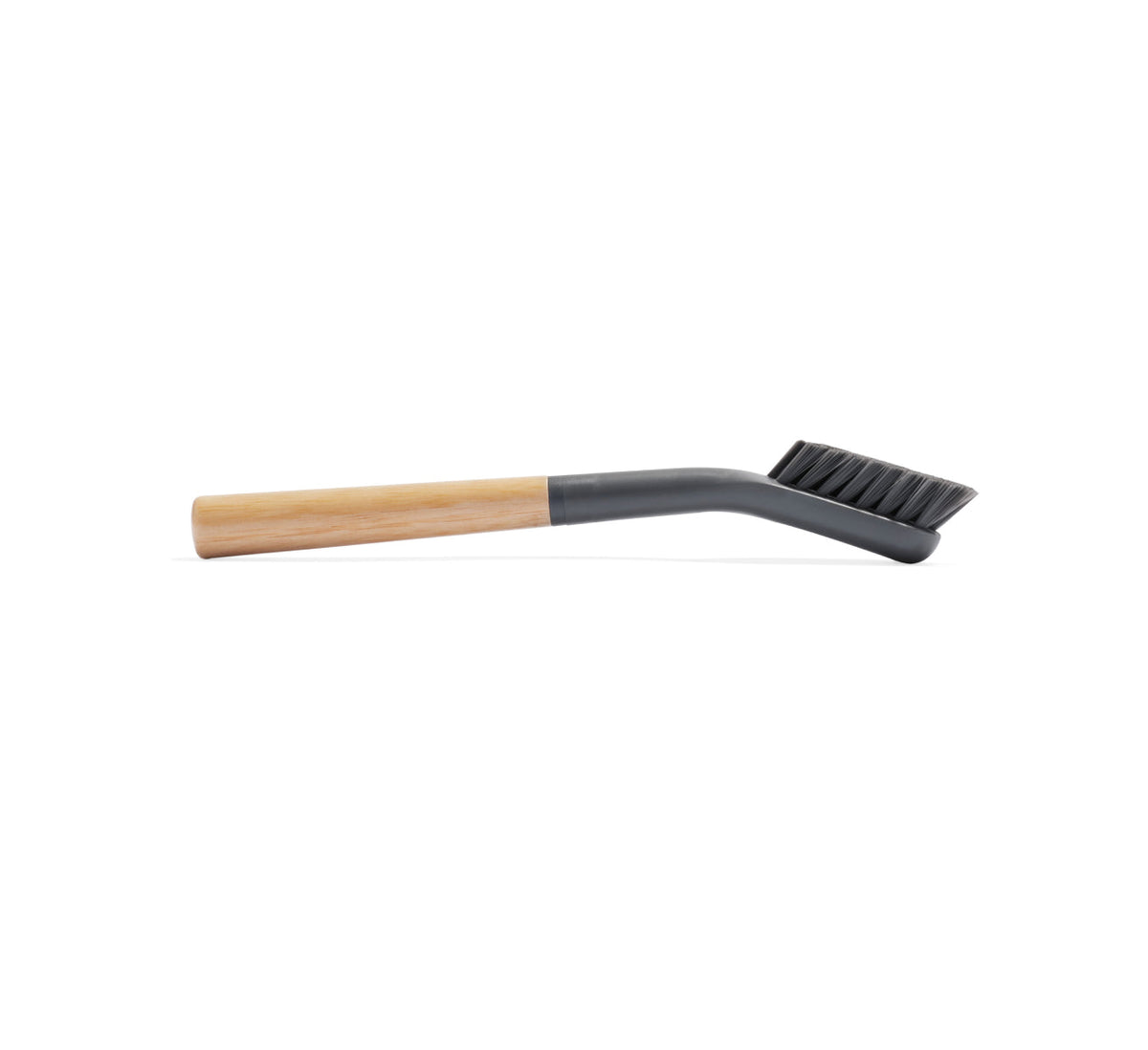 The Cleaning Brush features black bristles, a gray angled neck, and a light wooden handle, making it the ideal tool for cleaning your Nama M1 plant-based milk maker. Displayed against a white background.
