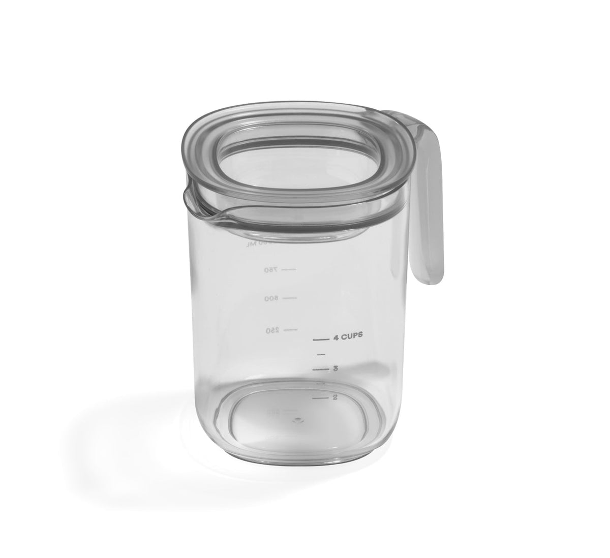 The Pitcher Set, featuring a clear plastic pitcher with a handle and a fitted lid marked with measurements up to 4 cups or 950 milliliters, is shown resting on a white surface.