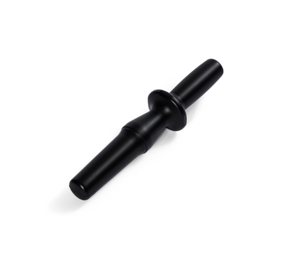 The Pusher is a black plastic tool with a central flange, designed to push ingredients into a blender jar or the Nama C2 Cold Press Juicer. Shown isolated on a white background.