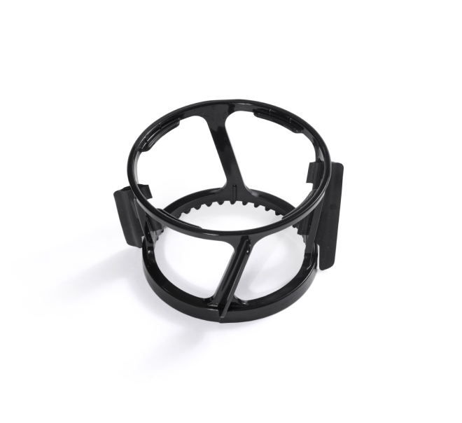 Black plastic circular spinning brush with three evenly spaced vertical dividers and side clips, shown on a white background. This removable component from the Nama C2 Cold Press Juicer is designed for use with the juicer’s strainer assembly.