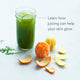 A glass of Skin Health green juice sits beside a peeled orange, tangerine, citrus peels, and arugula on a white surface. Text reads: Discover how Skin Health juicing can help your skin glow.