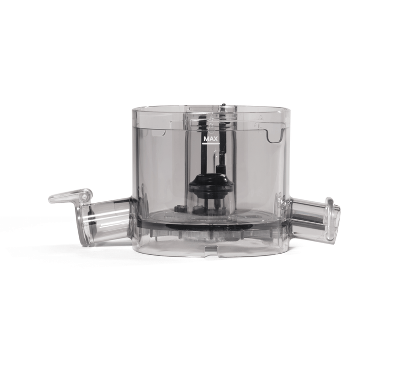 Certainly! Here’s a rewritten version of the sentence, using your product data: The Chamber is a transparent plastic food processor bowl featuring a handle on the left, a spout on the right, and an internal black blade attachment. Marked with “MAX” on its side to indicate the maximum fill level, this bowl—similar to the main chamber in appliances like the Nama J3 Cold Press Juicer—offers convenient capacity management for all your food preparation needs.
