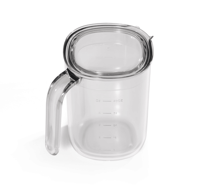 The Juice and Pulp Container Set features a clear plastic measuring cup with a handle and measurement markings—ideal as a juice or pulp container for your Nama J3 Cold Press Juicer.